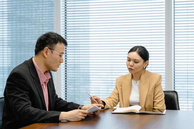 two people sitting accross each other in a meeting